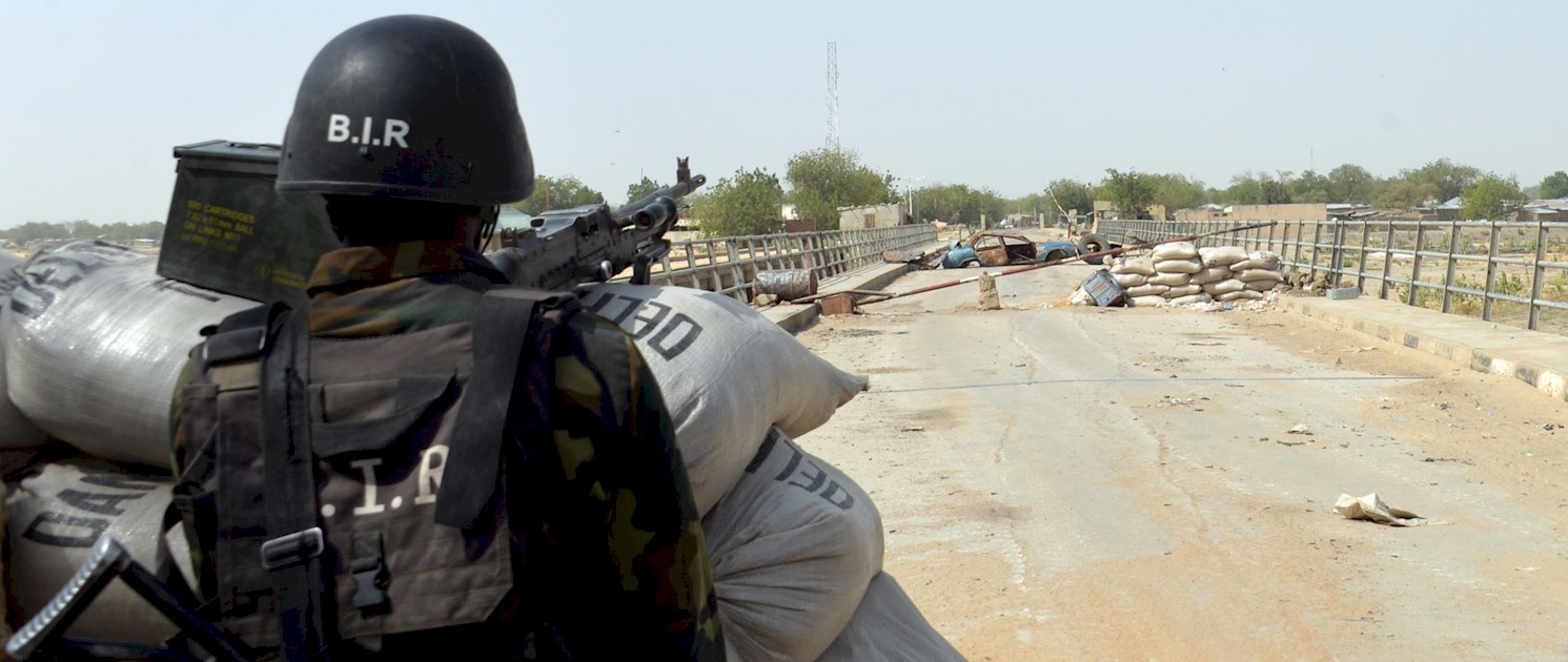 Picture: A Cameroonian Rapid Response Brigade Soldier with a mounted machine gun overlooking a stretch of land